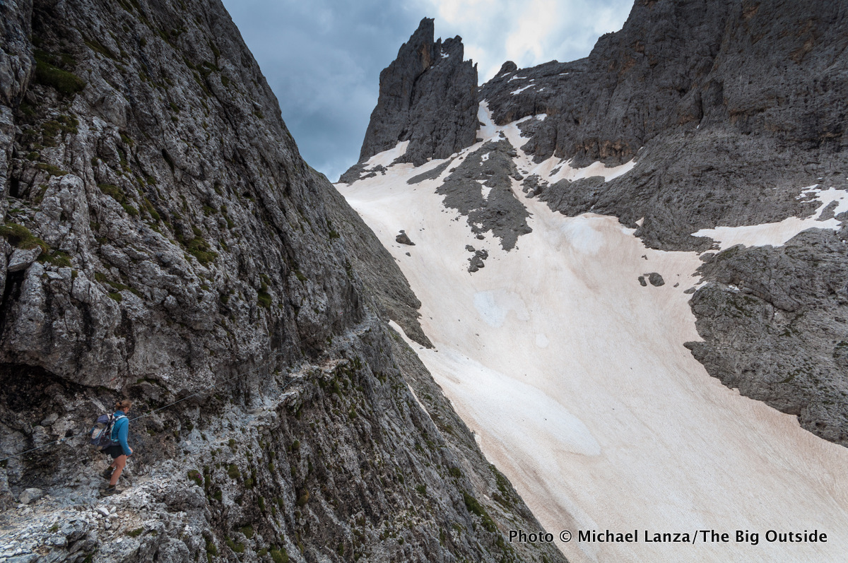 A trekker on the Alta Via 2 north of Ball Pass in Parco Naturale Paneveggio Pale di San Martino, Dolomite Mountains, Italy.