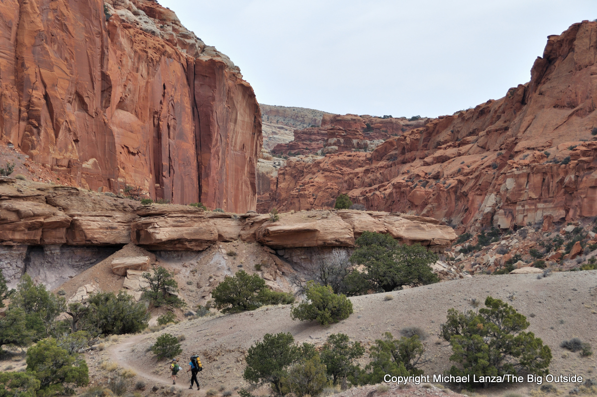 A mother and young daughter hiking Chimney Rock Canyon in Capitol Reef National Park.