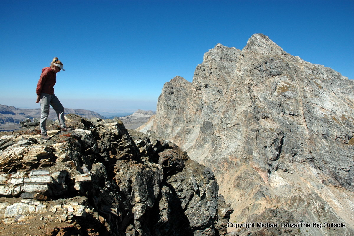 A hiker on the summit of Static Peak in Grand Teton National Park.