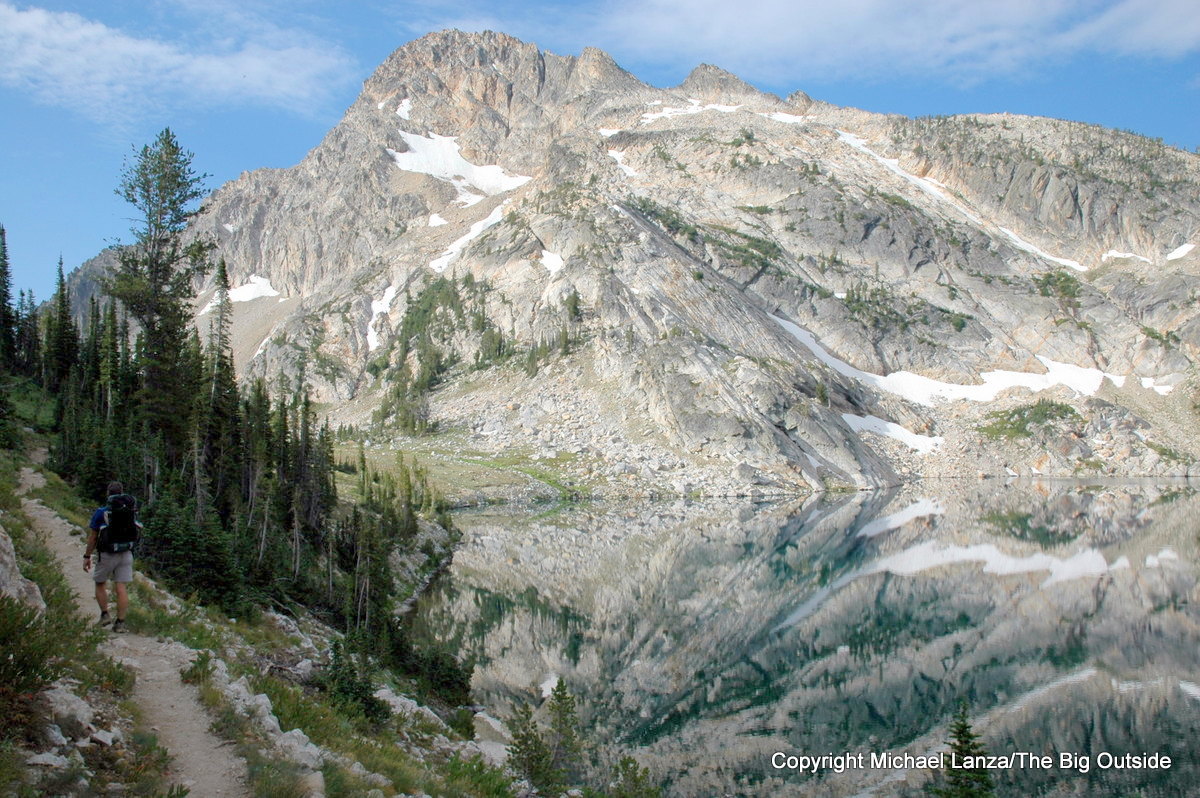 A hiker along the shore of Sawtooth Lake in Idaho's Sawtooth Mountains