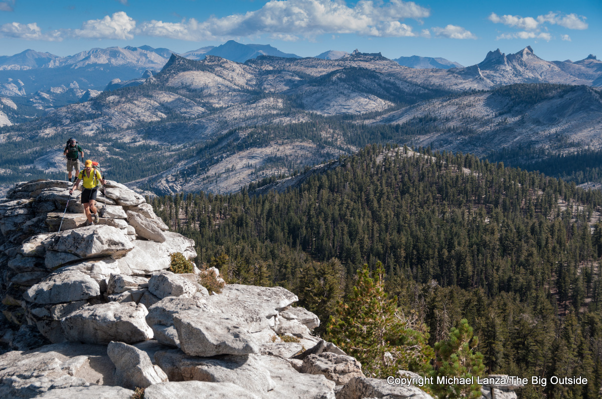 Backpackers hiking over Clouds Rest in Yosemite National Park.