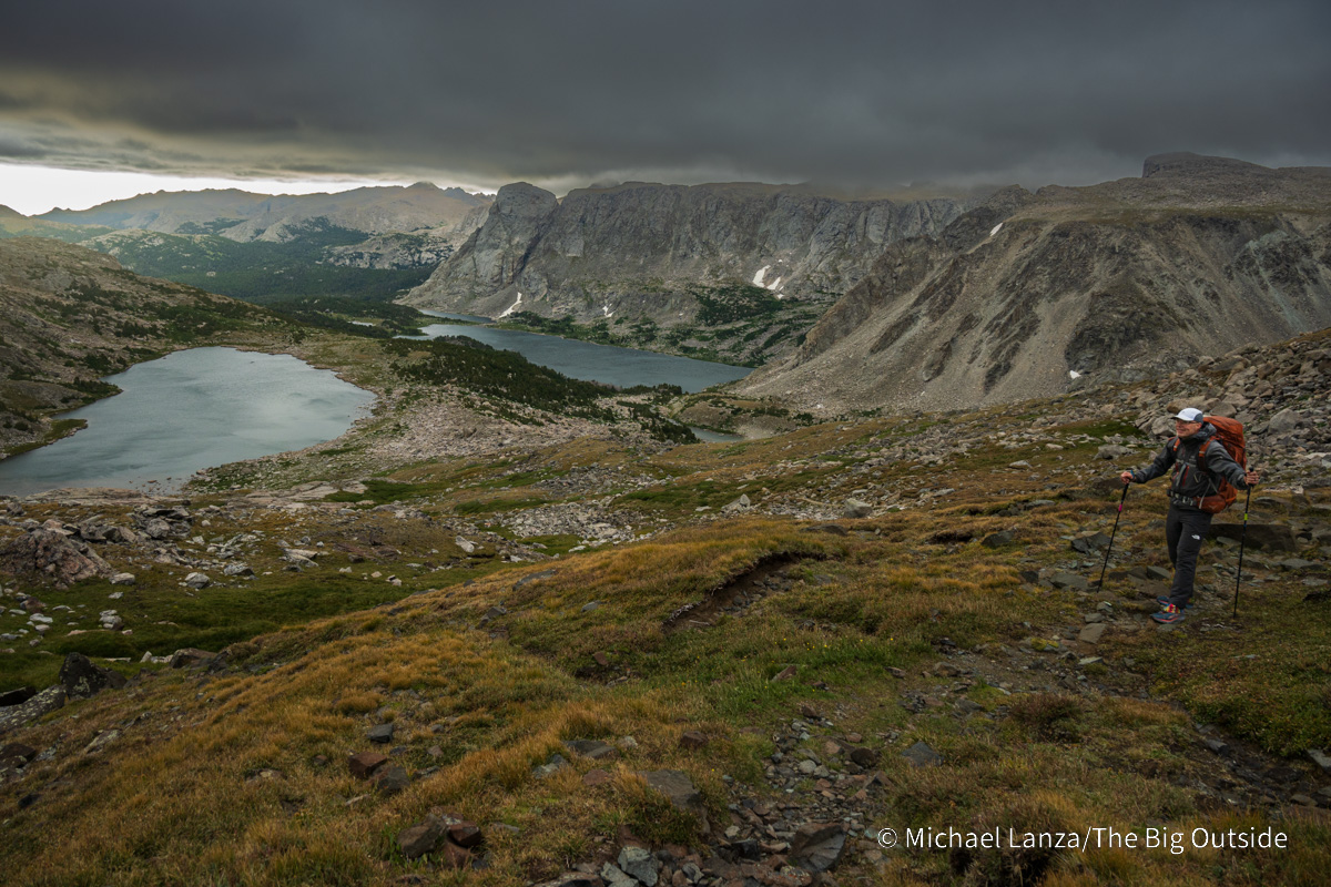 A backpacker above Macon Lake and Washakie Lake in the Wind River Range, Wyoming.