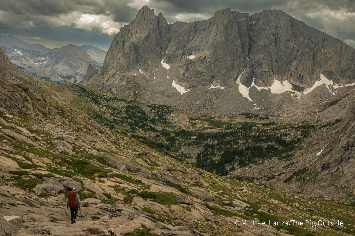 A backpacker descending from Texas Pass into the Cirque of the Towers in the Wind River Range, Wyoming.