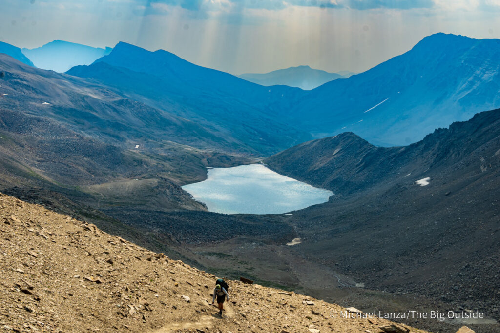 A backpacker hiking above Curator Lake toward the Notch, along the Skyline Trail in Jasper National Park. A backpacker hiking above Curator Lake toward the Notch, along the Skyline Trail in Jasper National Park.