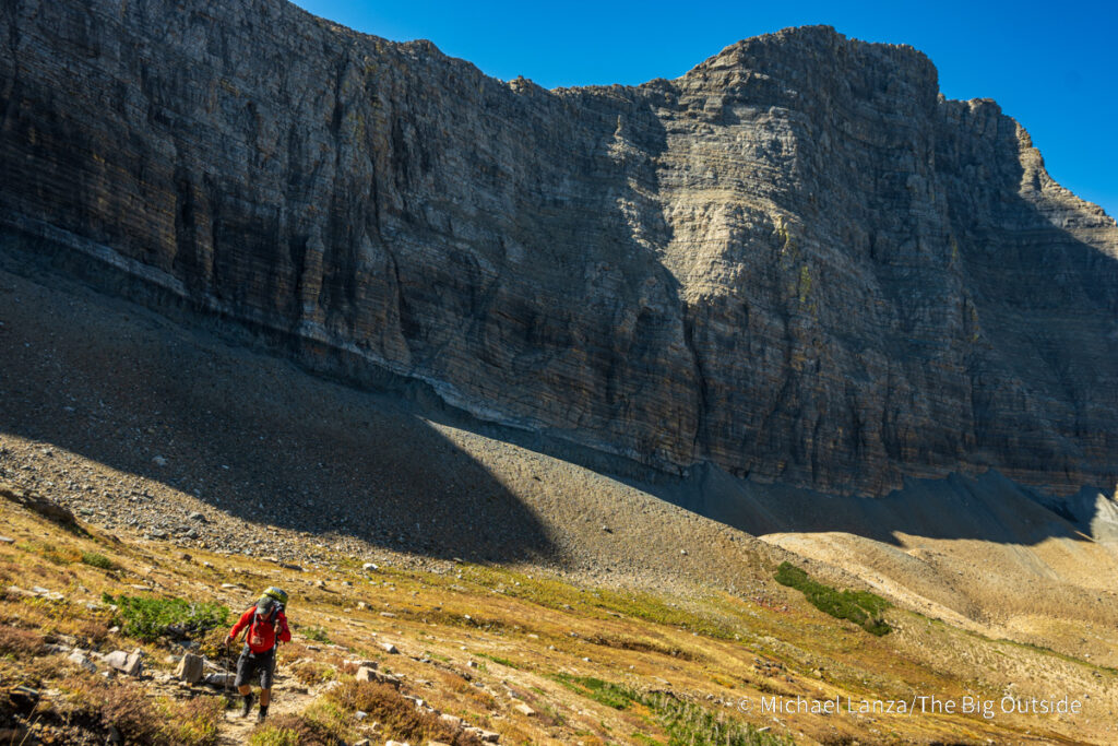 A backpacker hiking the Continental Divide Trail in Glacier National Park. A backpacker hiking the Continental Divide Trail in Glacier National Park.