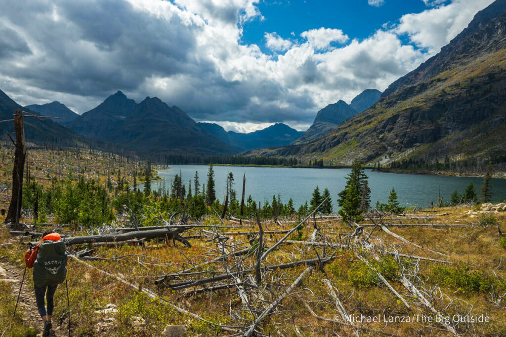 A backpacker hiking to Red Eagle Lake in Glacier National Park. A backpacker hiking to Red Eagle Lake in Glacier National Park.