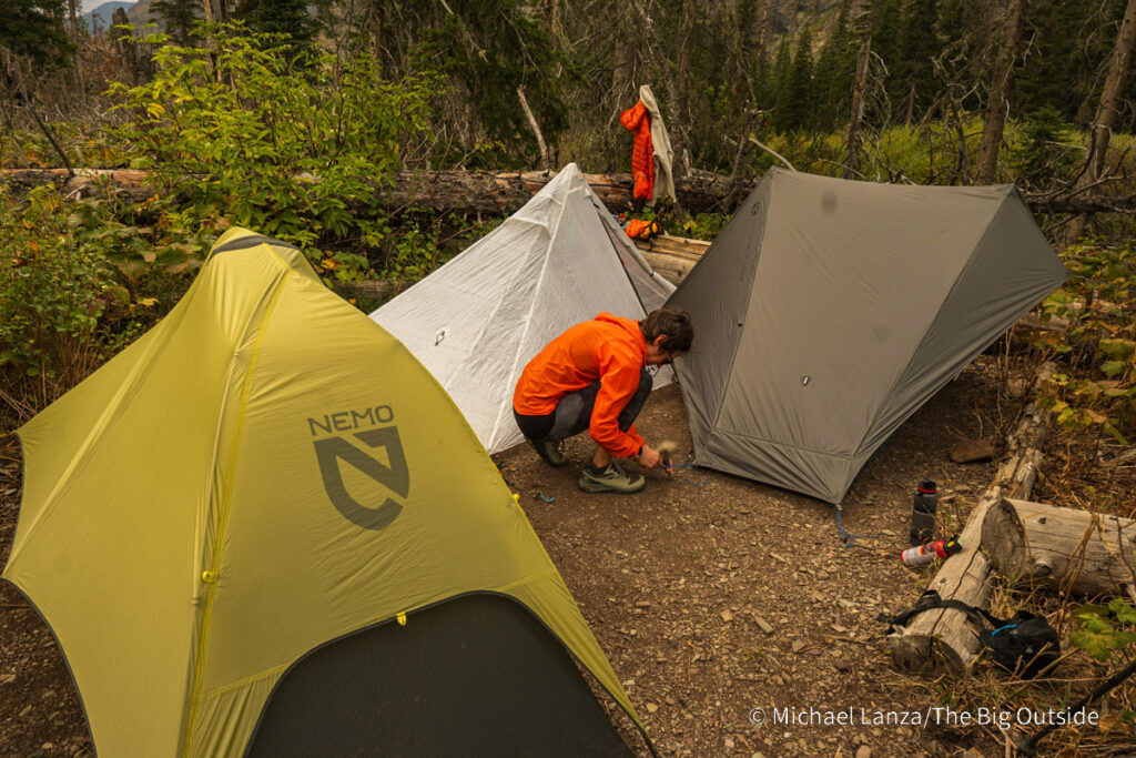 Three solo backpacker tents crowded into a campsite at Red Eagle Lake in Glacier National Park. Three solo backpacker tents crowded into a campsite at Red Eagle Lake in Glacier National Park.