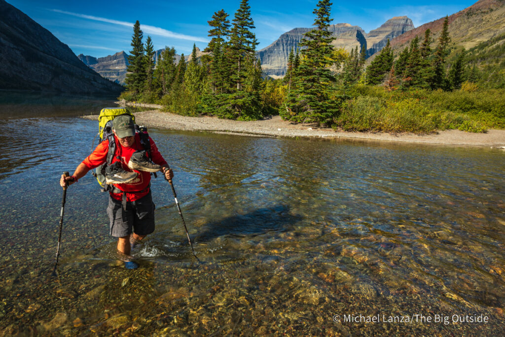 A backpacker crossing the Belly River in Glacier National Park. A backpacker crossing the Belly River in Glacier National Park.