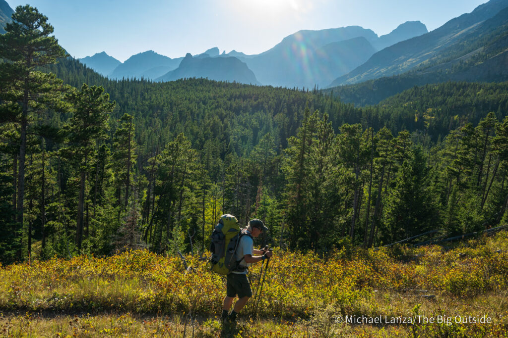 A backpacker hiking up the Belly River Valley in Glacier National Park. A backpacker hiking up the Belly River Valley in Glacier National Park.