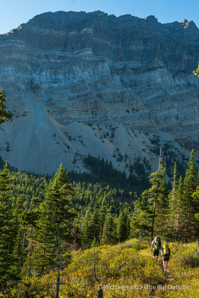 Backpackers hiking up the Belly River Valley in Glacier National Park. Backpackers hiking up the Belly River Valley in Glacier National Park.