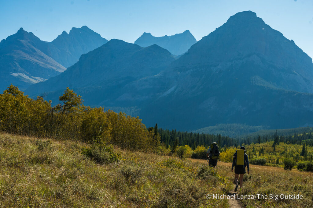 Backpackers hiking up the Belly River Valley in Glacier National Park. Backpackers hiking up the Belly River Valley in Glacier National Park.