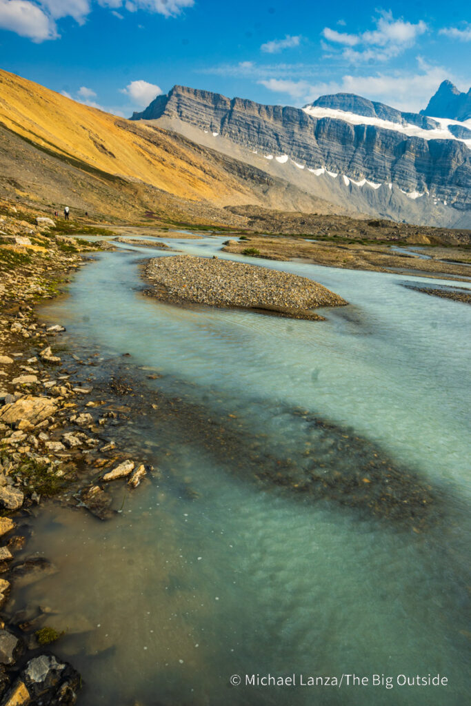 A backpacker hiking the Nigel, Cataract, and Cline Passes Route in the upper Brazeau River Valley in Jasper National Park, Canadian Rockies. A backpacker hiking the Nigel, Cataract, and Cline Passes Route in the upper Brazeau River Valley in Jasper National Park, Canadian Rockies.