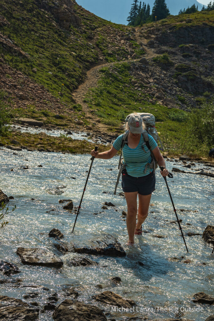A backpacker crossing the Brazeau River at Nigel Pass in Jasper National Park, Canadian Rockies. A backpacker crossing the Brazeau River at Nigel Pass in Jasper National Park, Canadian Rockies.