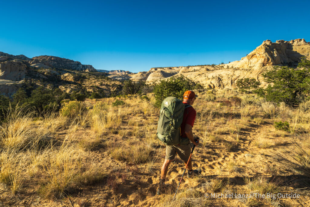 A backpacker hiking the Boulder Mail Trail in Utah's Grand Staircase-Escalante National Monument. A backpacker hiking the Boulder Mail Trail in Utah's Grand Staircase-Escalante National Monument.