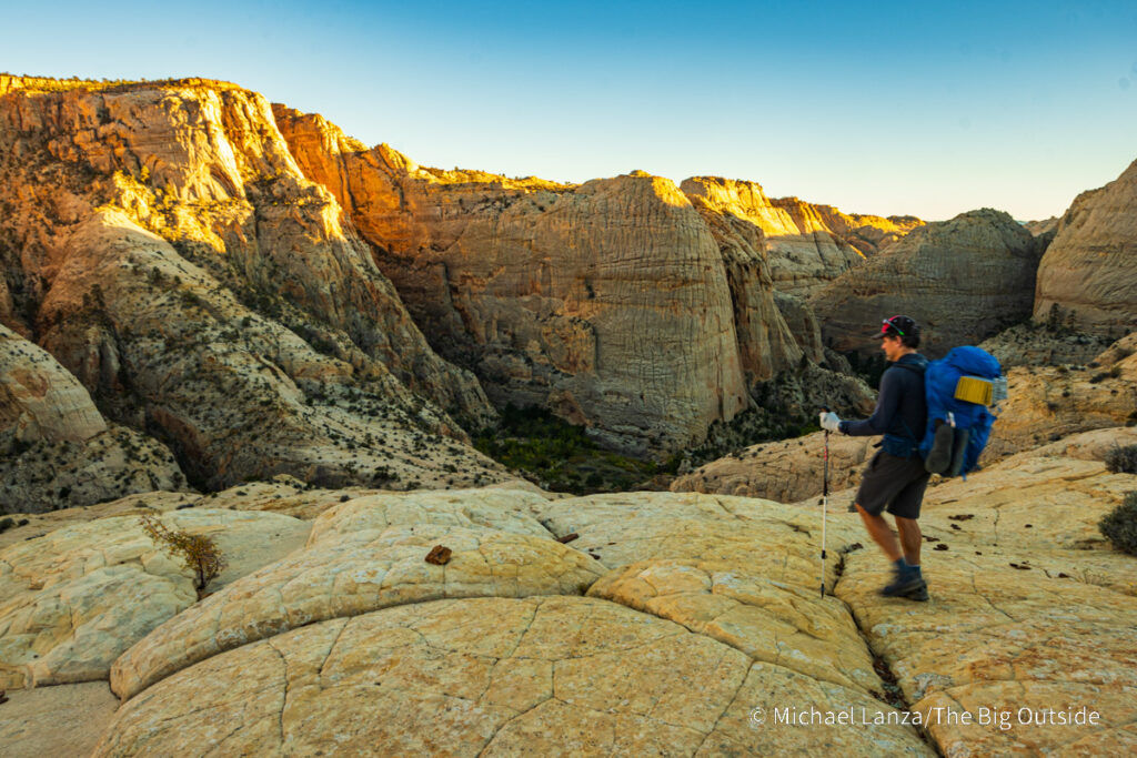 A backpacker hiking the Boulder Mail Trail above Death Hollow in Utah's Grand Staircase-Escalante National Monument. A backpacker hiking the Boulder Mail Trail above Death Hollow in Utah's Grand Staircase-Escalante National Monument.