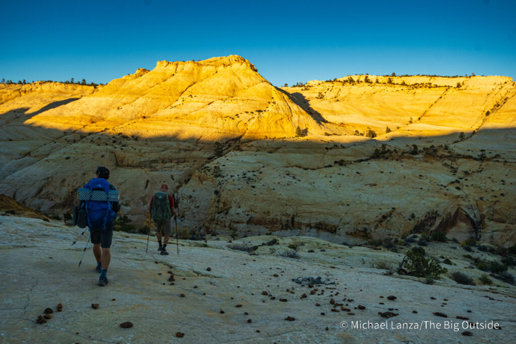 Backpackers descending into Death Hollow on southern Utah's Boulder Mail Trail. Backpackers descending into Death Hollow on southern Utah's Boulder Mail Trail.
