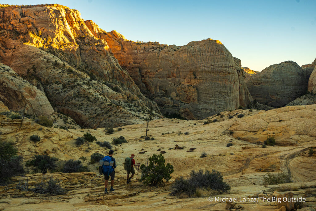 Backpackers descending into Death Hollow on southern Utah's Boulder Mail Trail. Backpackers descending into Death Hollow on southern Utah's Boulder Mail Trail.
