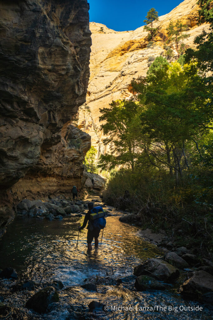 Backpackers hiking down Death Hollow in southern Utah's Grand Staircase-Escalante National Monument. Backpackers hiking down Death Hollow in southern Utah's Grand Staircase-Escalante National Monument.