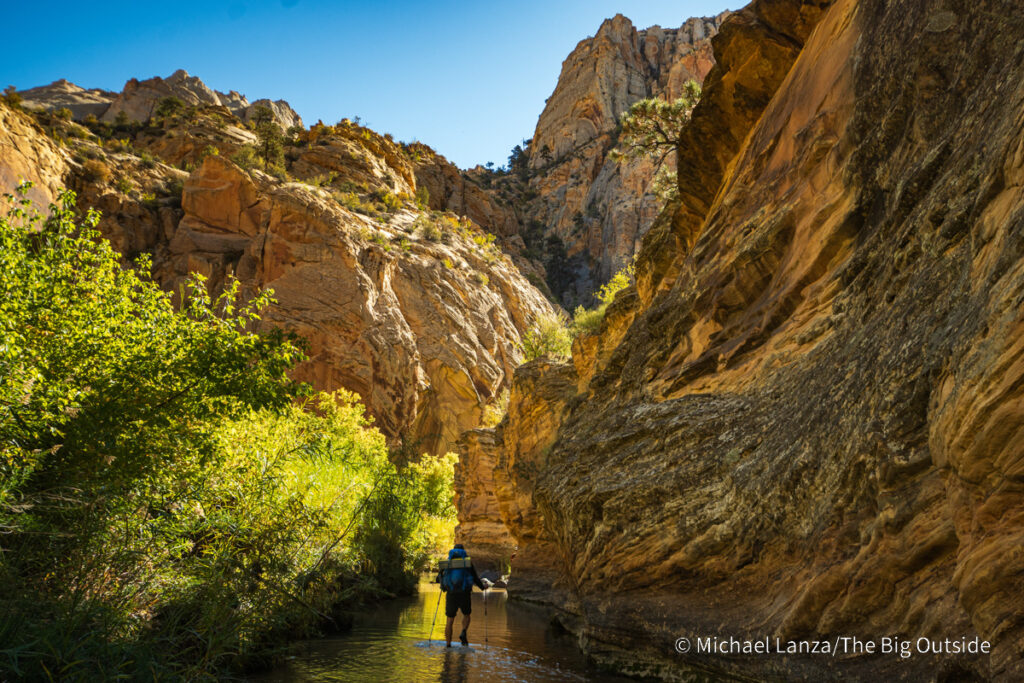 A backpacker hiking down Death Hollow in southern Utah's Grand Staircase-Escalante National Monument. A backpacker hiking down Death Hollow in southern Utah's Grand Staircase-Escalante National Monument.