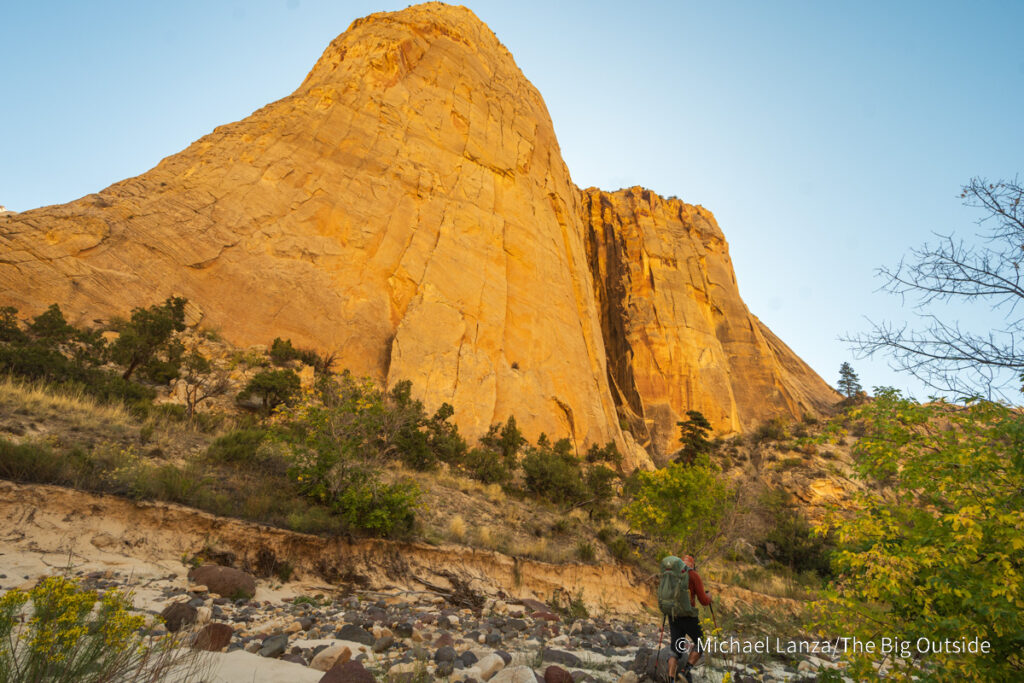 A backpacker hiking down Death Hollow in southern Utah's Grand Staircase-Escalante National Monument. A backpacker hiking down Death Hollow in southern Utah's Grand Staircase-Escalante National Monument.