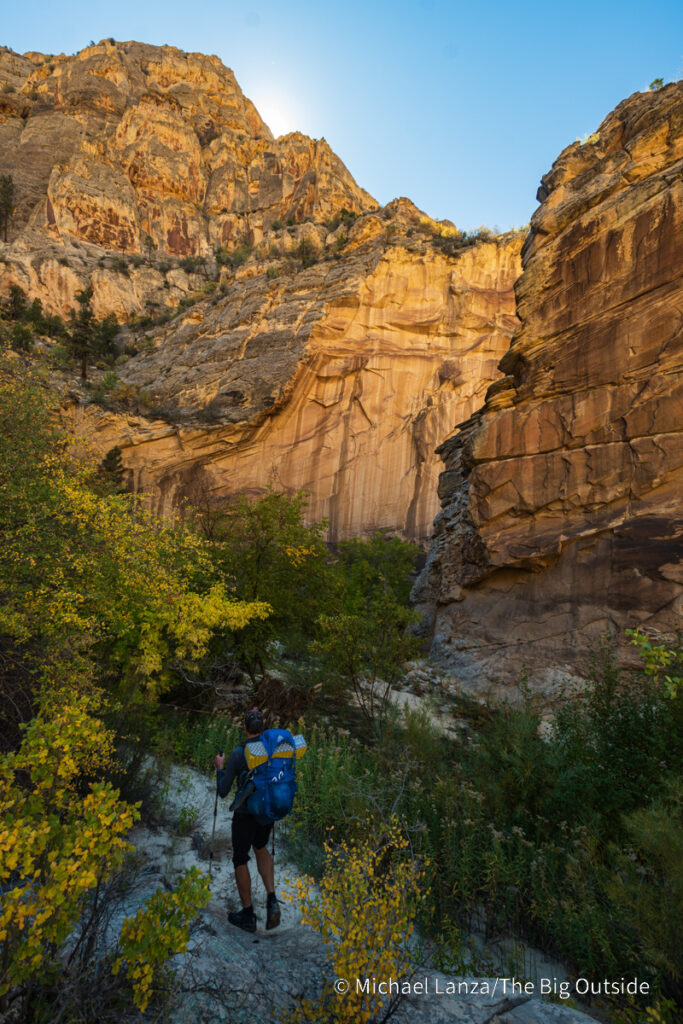 A backpacker hiking down Death Hollow in southern Utah's Grand Staircase-Escalante National Monument. A backpacker hiking down Death Hollow in southern Utah's Grand Staircase-Escalante National Monument.