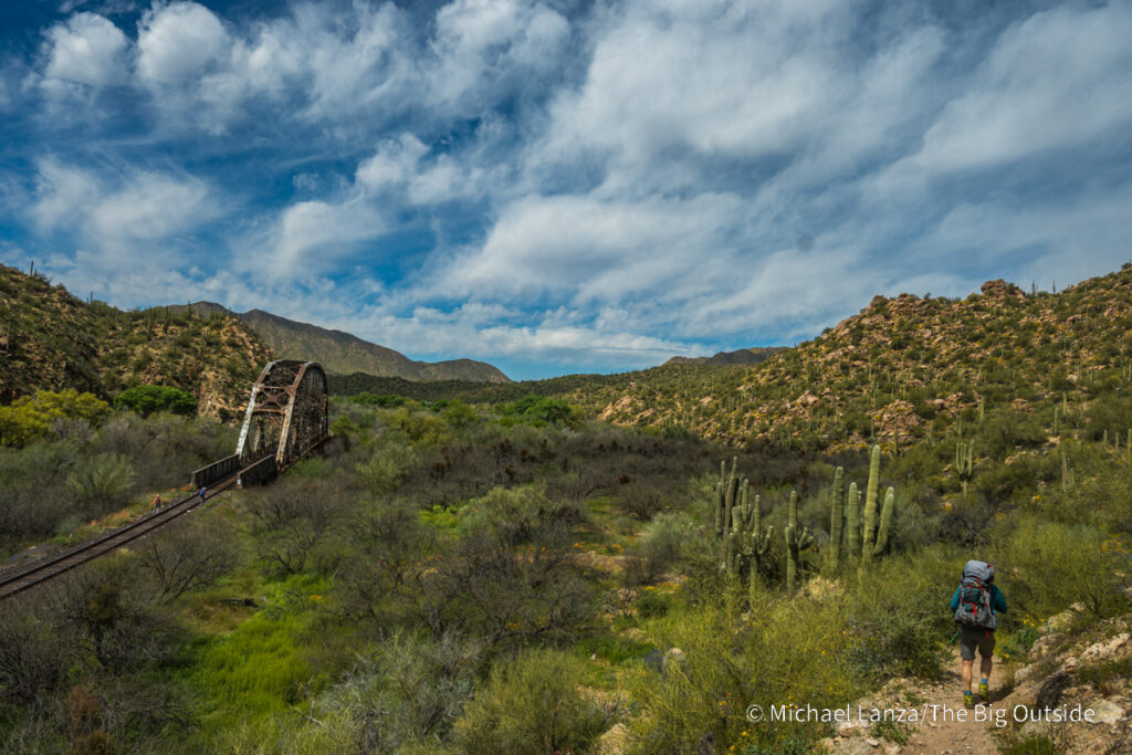 A backpacker hiking the Arizona Trail's Passage 16 in the Gila River Canyon. A backpacker hiking the Arizona Trail's Passage 16 in the Gila River Canyon.