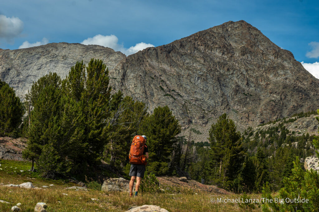 A backpacker hiking the CDT toward Pyramid Peak in the Wind River Range, Wyoming. A backpacker hiking the CDT toward Pyramid Peak in the Wind River Range, Wyoming.