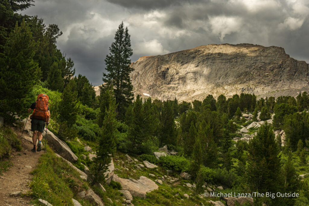 A backpacker hiking the Pyramid Lake Trail in the Wind River Range, Wyoming. A backpacker hiking the Pyramid Lake Trail in the Wind River Range, Wyoming.