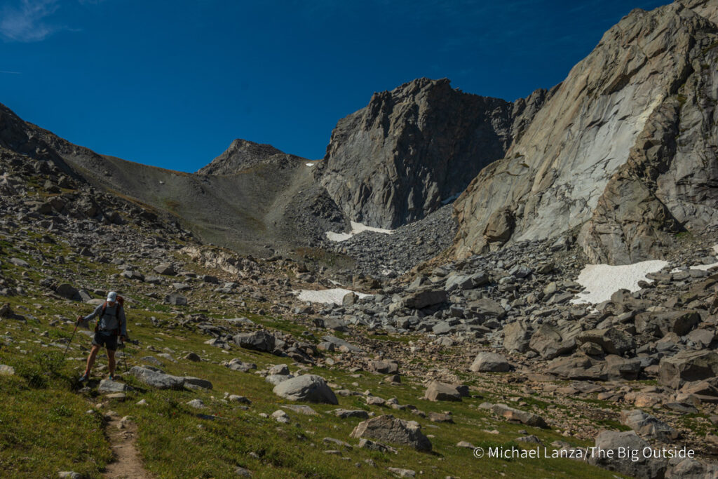 A backpacker hiking north of Hailey Pass in the Wind River Range, Wyoming. A backpacker hiking north of Hailey Pass in the Wind River Range, Wyoming.
