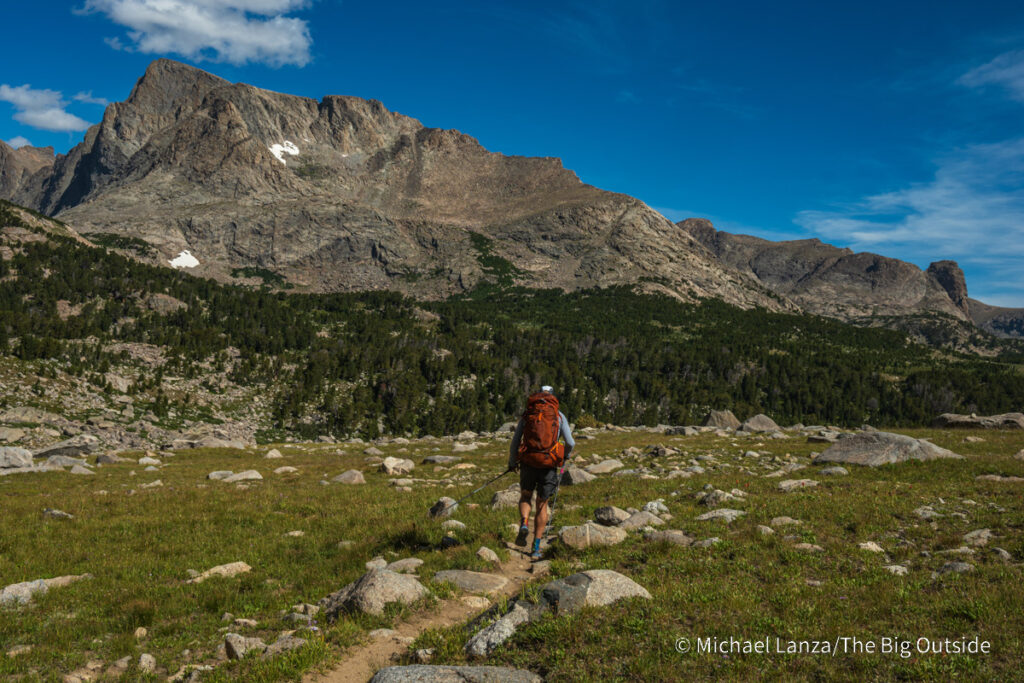 A backpacker hiking north of Hailey Pass in the Wind River Range, Wyoming. A backpacker hiking north of Hailey Pass in the Wind River Range, Wyoming.