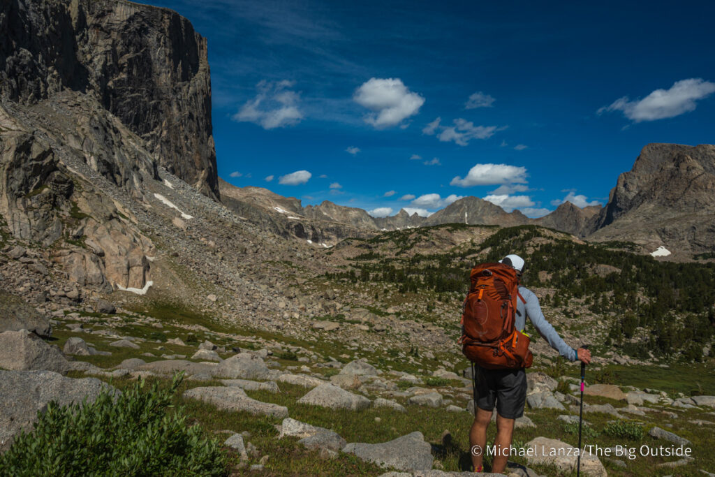 A backpacker looking toward the Baptiste Lake basin in the Wind River Range, Wyoming. A backpacker looking toward the Baptiste Lake basin in the Wind River Range, Wyoming.