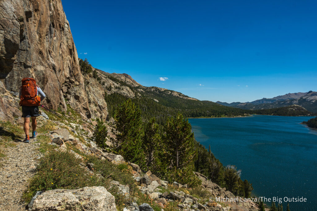 A backpacker hiking the Bears Ears Trail above Grave Lake in the Wind River Range, Wyoming. A backpacker hiking the Bears Ears Trail above Grave Lake in the Wind River Range, Wyoming.