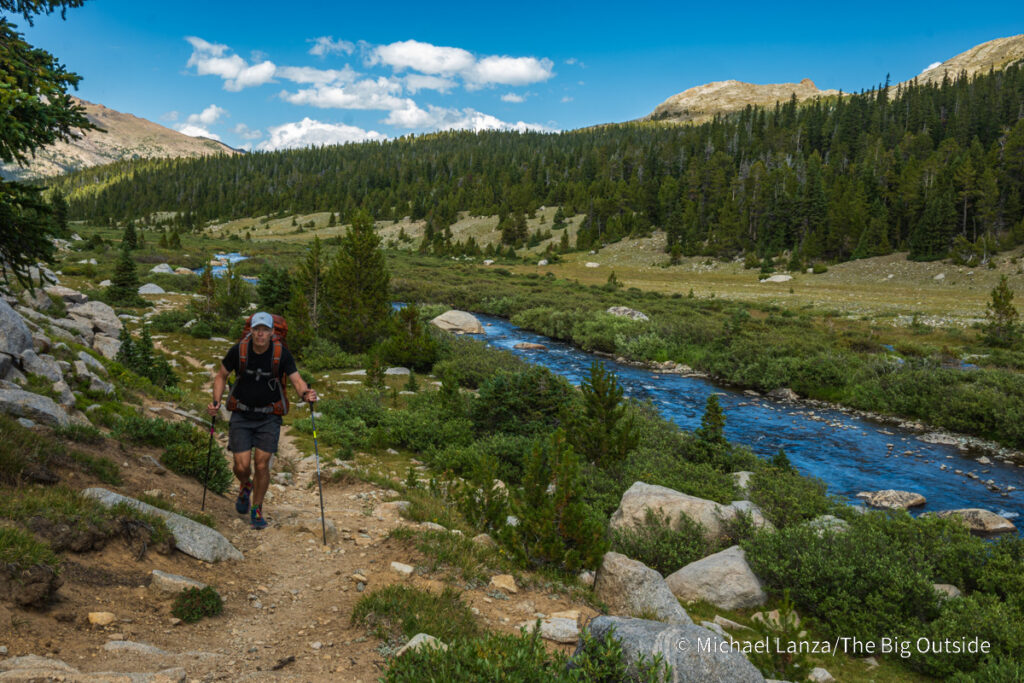 A backpacker hiking the Bears Ears Trail along the South Fork Wind River in the Wind River Range, Wyoming. A backpacker hiking the Bears Ears Trail along the South Fork Wind River in the Wind River Range, Wyoming.