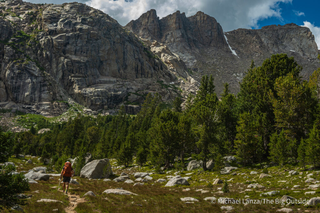 A backpacker hiking the Washakie Pass Trail in the Wind River Range, Wyoming. A backpacker hiking the Washakie Pass Trail in the Wind River Range, Wyoming.