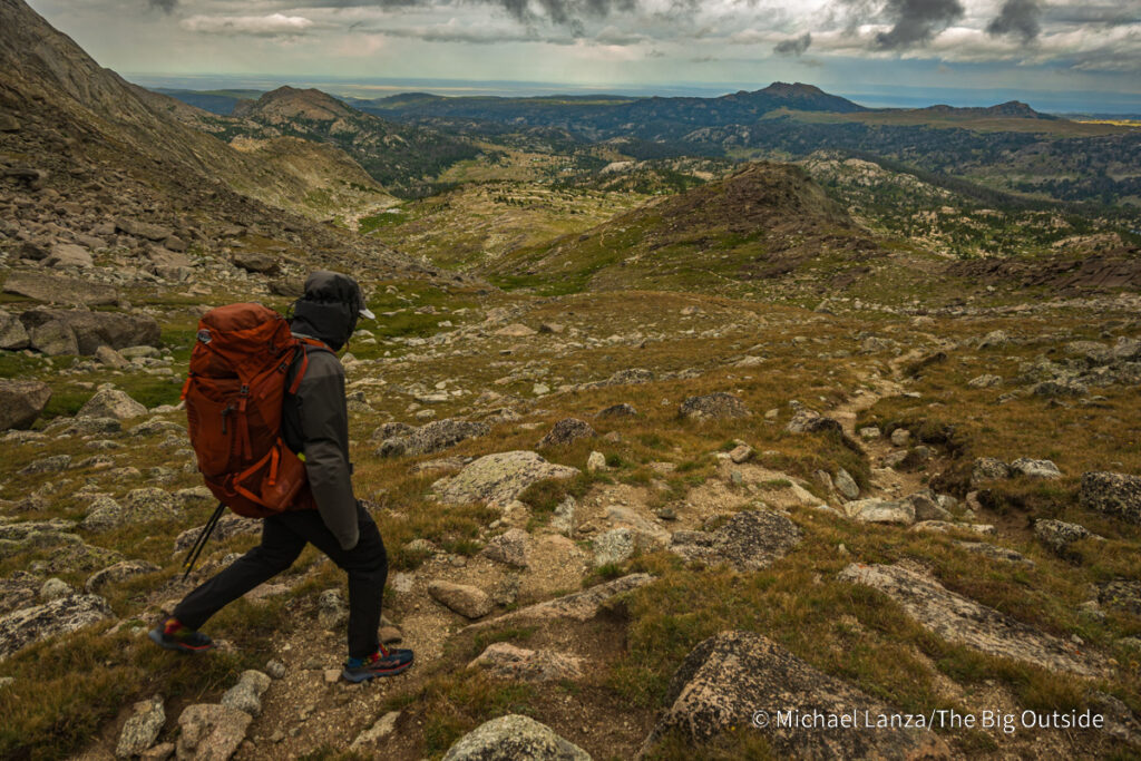A backpacker hiking the Washakie Pass Trail in the Wind River Range, Wyoming. A backpacker hiking the Washakie Pass Trail in the Wind River Range, Wyoming.