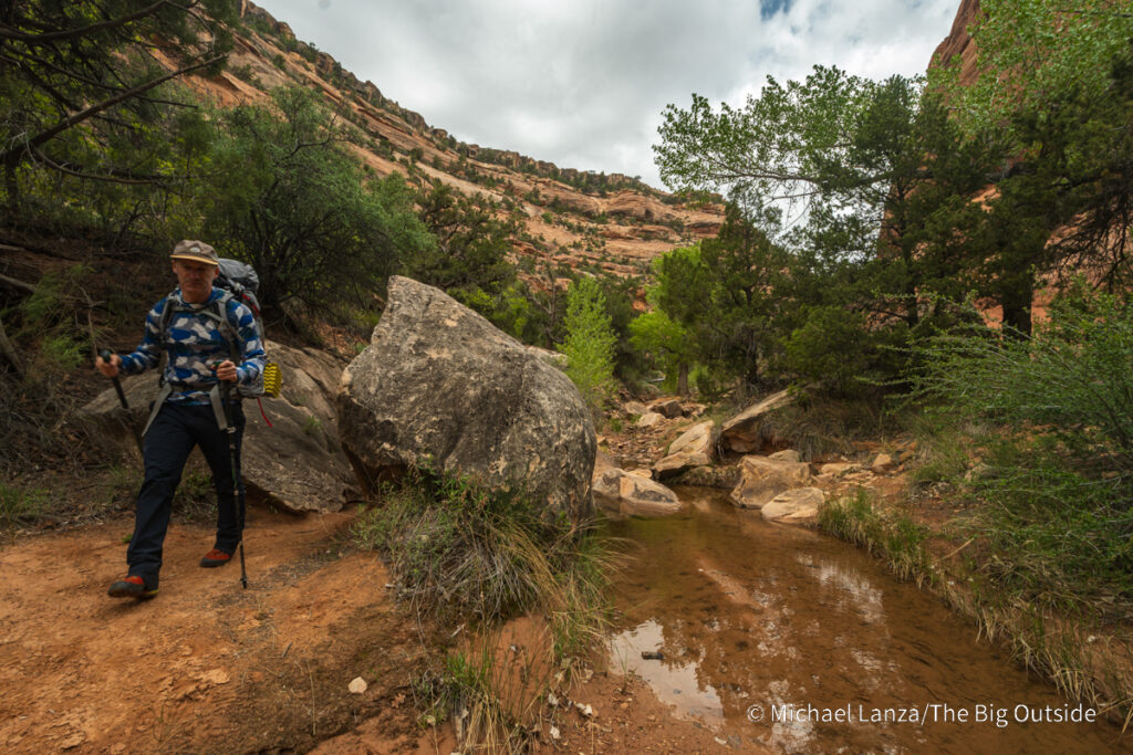 A backpacker hiking in Owl Canyon, Bears Ears National Monument, Utah.