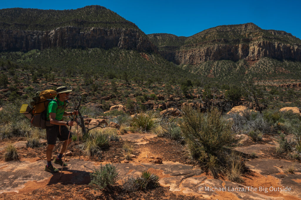 A backpacker hiking down the South Bass Trail in the Grand Canyon.