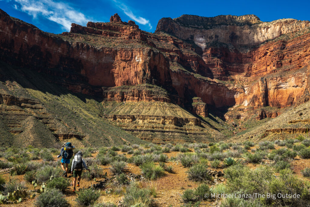 Backpackers hiking the Tonto Trail east toward Turquoise Canyon, along the Gems Route in the Grand Canyon.