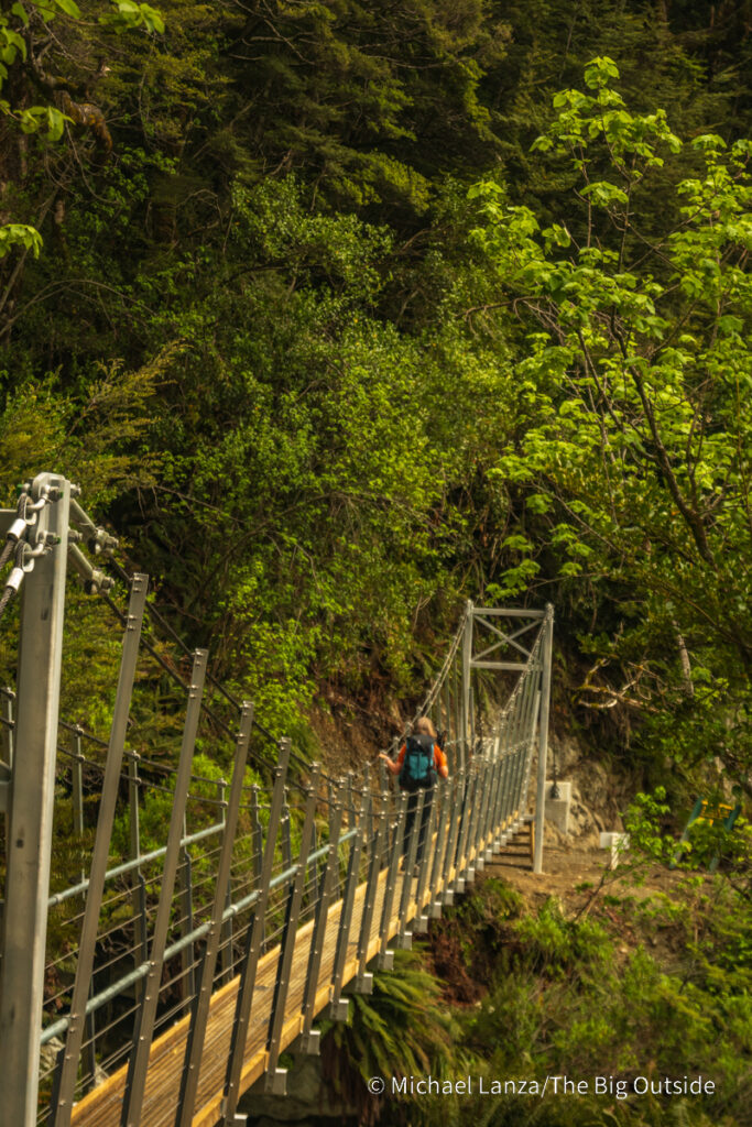 A trekker hiking the Routeburn Track in Mount Aspiring National Park, New Zealand. A trekker hiking the Routeburn Track in Mount Aspiring National Park, New Zealand.