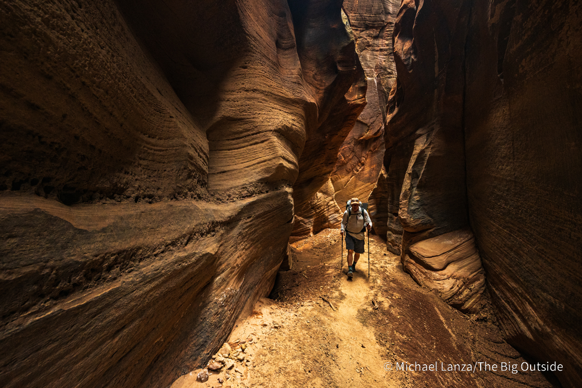 A backpacker hiking Buckskin Gulch in southern Utah.