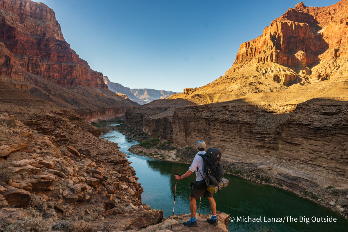 A backpacker hiking the Beamer Trail above the Colorado River in the Grand Canyon.
